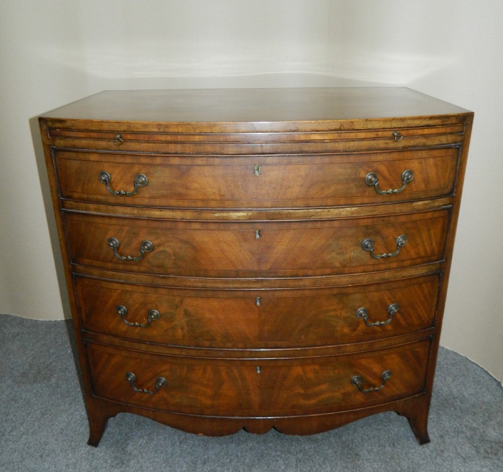 small mahogany bowfront chest of drawers with brushing slide