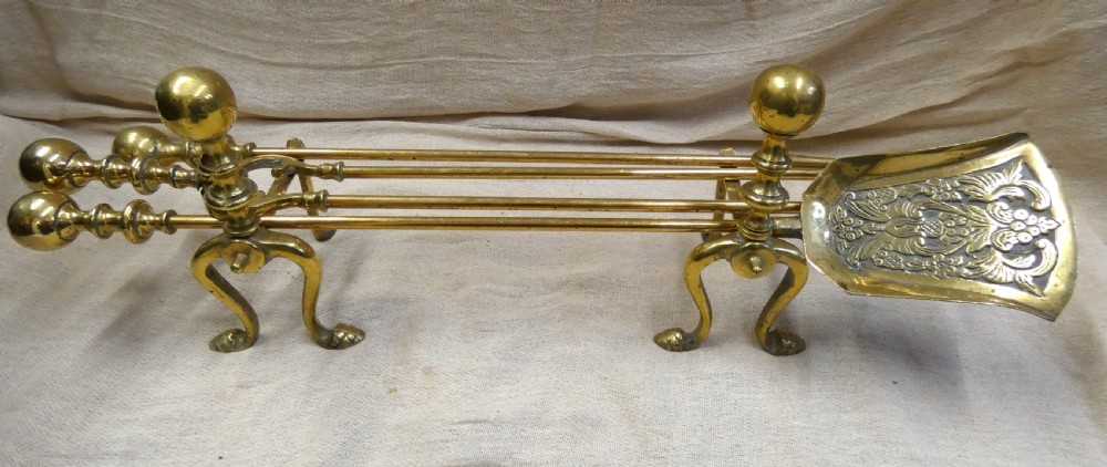 brass andirons with set of fire tools